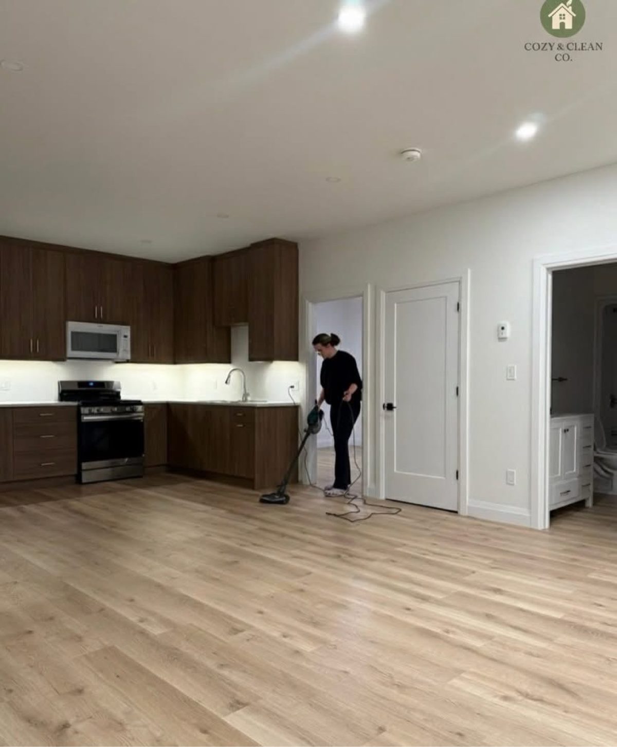Cozy & Clean team member cleaning a kitchen floor